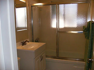 Bathroom with vanity and shower doors