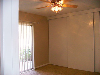 Bedroom with new brushed nickel Ceiling Fan and large closet